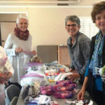 Members filling Purses with necessities for homeless women